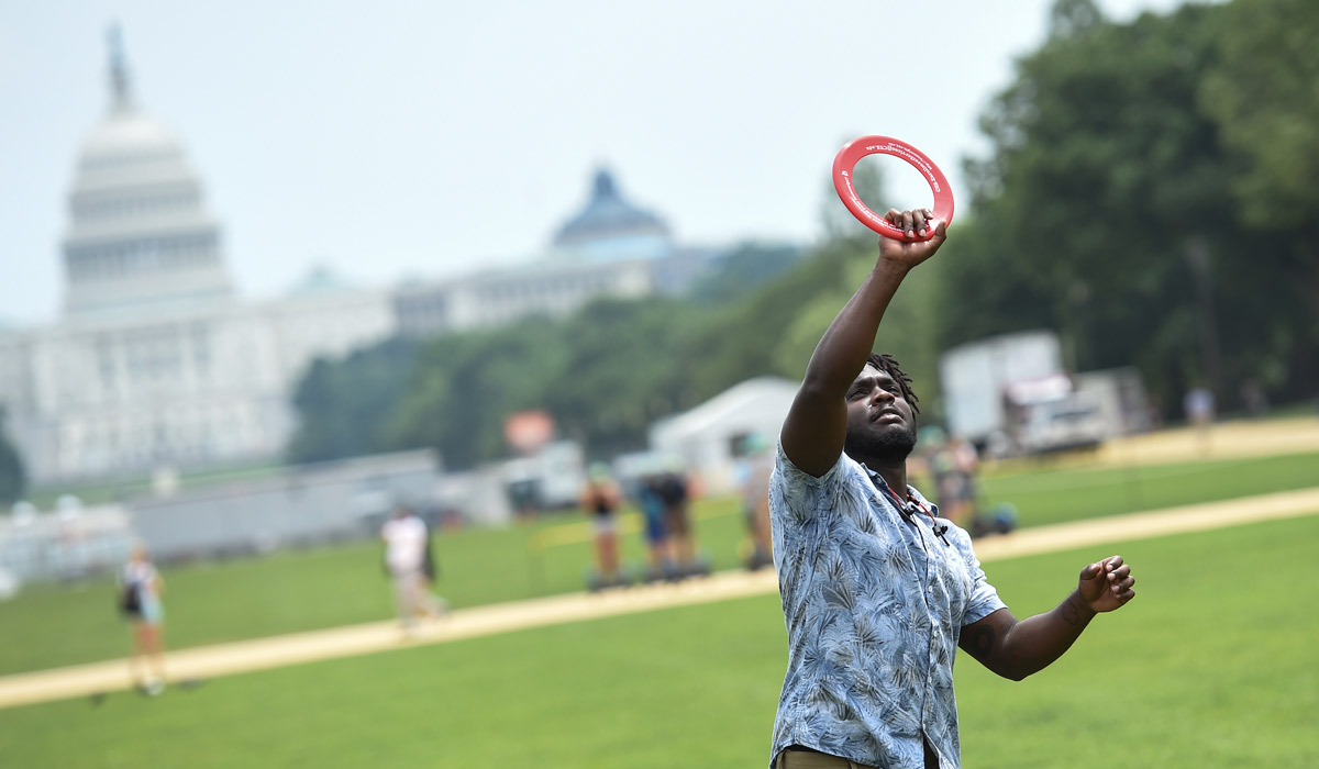 Student playing Frisbee on National Mall