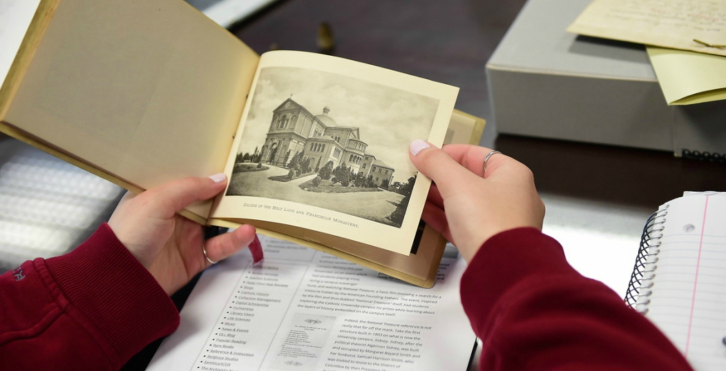 student holding a book